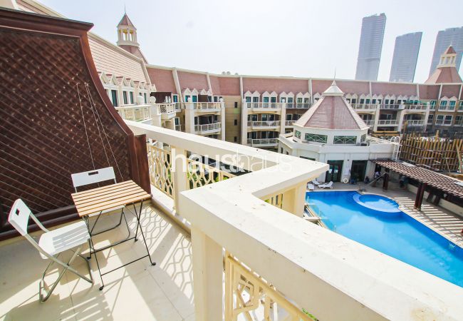  in Dubai -  Balcony | Pool view | Cozy Apartment
